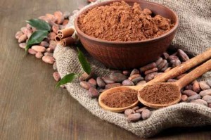 Cocoa powder and cocoa beans  on wooden background